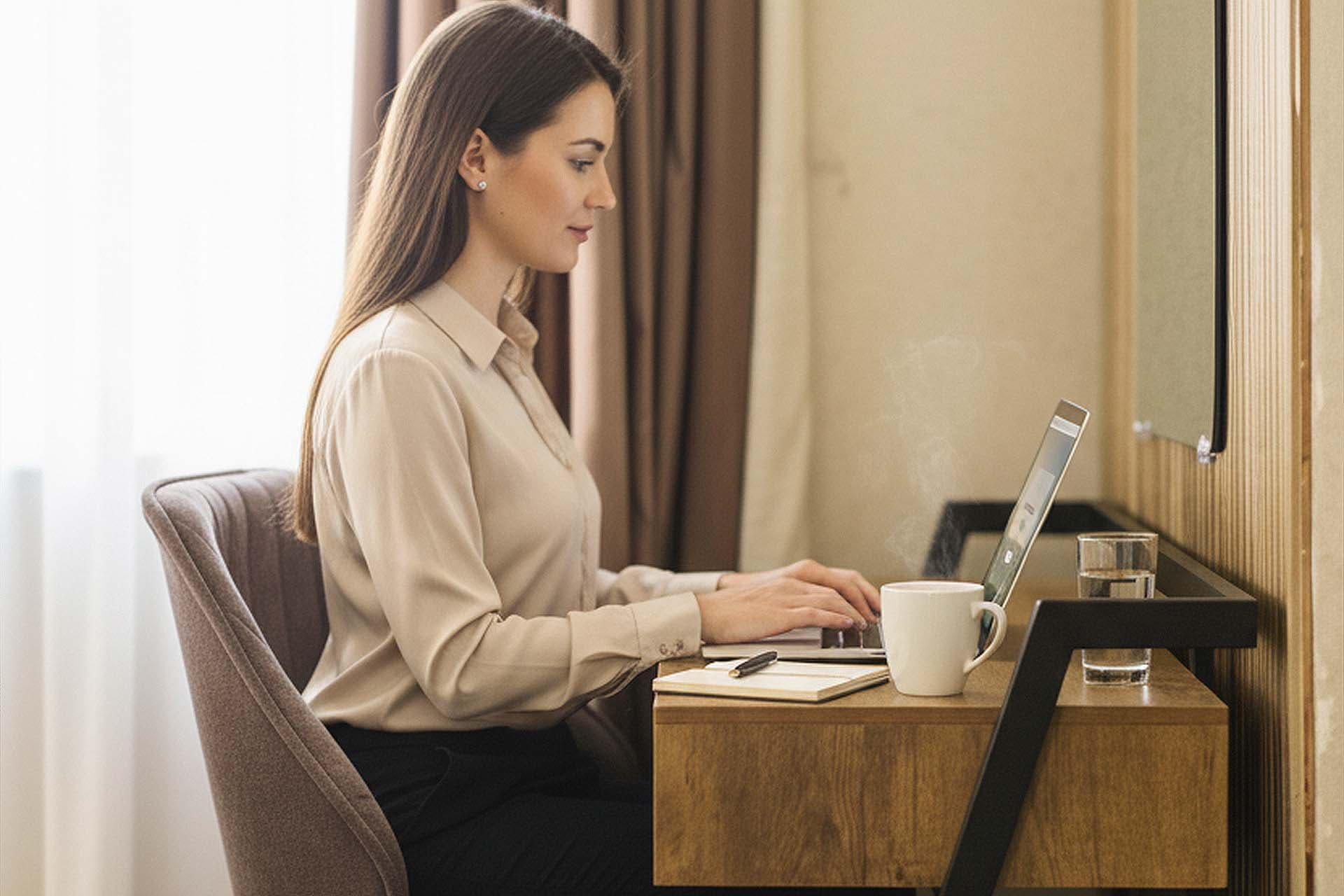  Business traveler working from LEORK Hotels Rawalpindi with modern workspace.