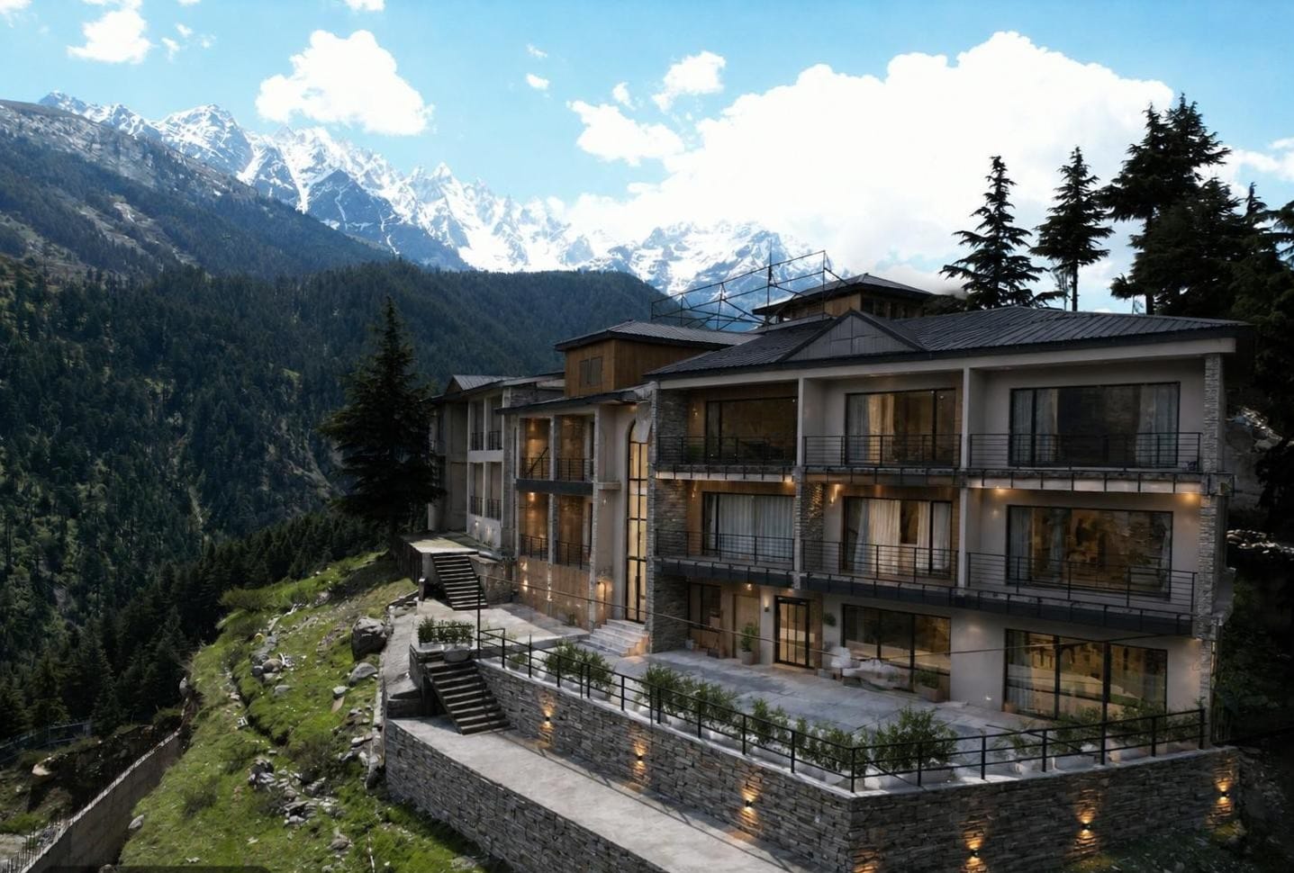 LEORK Hotel Kalam exterior with snow-capped Swat Valley peaks