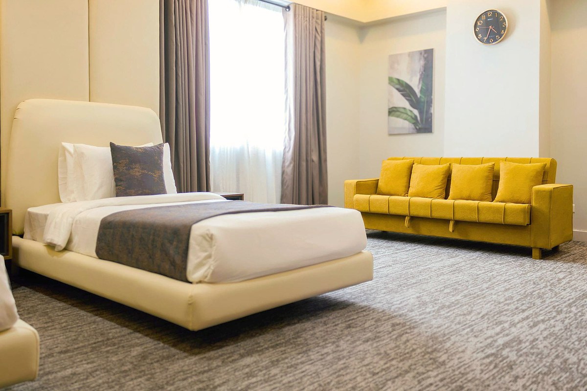 LEORK Twin room with a yellow sofa by a large window, a place for an attendant to rest