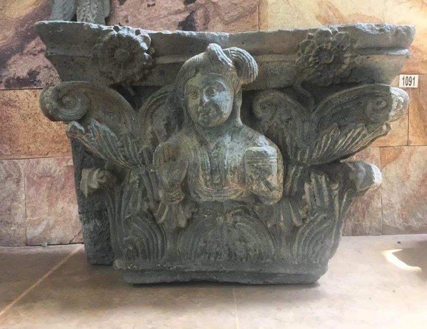 Gandharan carved capital with a devotee figure from Butkara I, on display in the Swat Museum