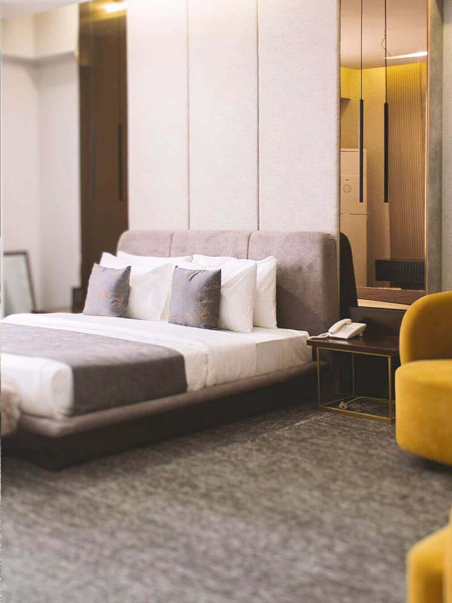 Deluxe King room at LEORK Hotels Rawalpindi with a plush bed and modern styling on the GT Road corridor