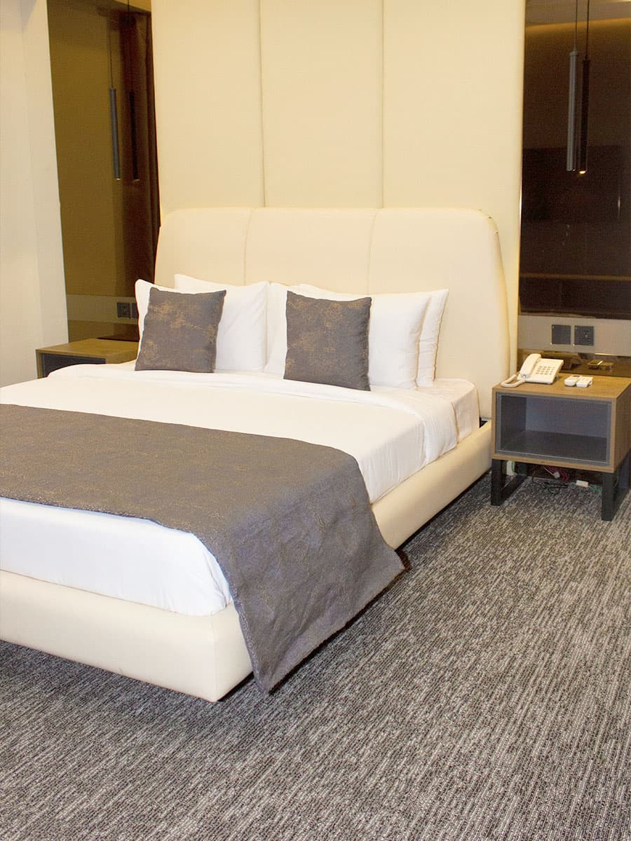King room at LEORK Hotels Rawalpindi with a large bed and calm modern interior, close to Fauji Foundation Hospital